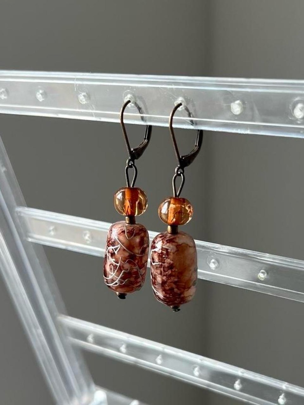 tortoiseshell glass dangly earrings with silver chrome design and amber beads